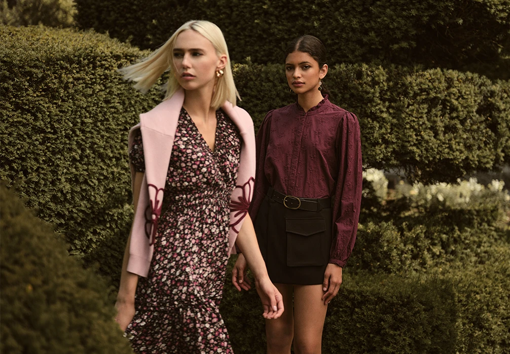 A girl standing in a dress. Text on image: Get set for the season ahead with transitional styles designed to take you through summer and beyond. Discover versatile mini dresses, midi dresses and maxi dresses made for late summer sunshine and early autumn events. As the weather cools, shrug on cosy cardigans and women's lightweight jumpers from our new knitwear collection. Give your wardrobe a seasonal update with casual T-shirts, tops, and work-to-weekend shirts and trousers. Explore the A/W25 women's pre-collection at Apricot..