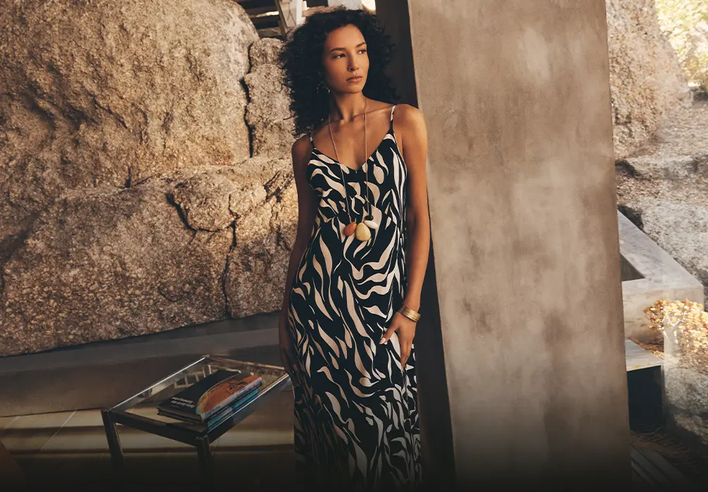 Model wearing black and white print dress