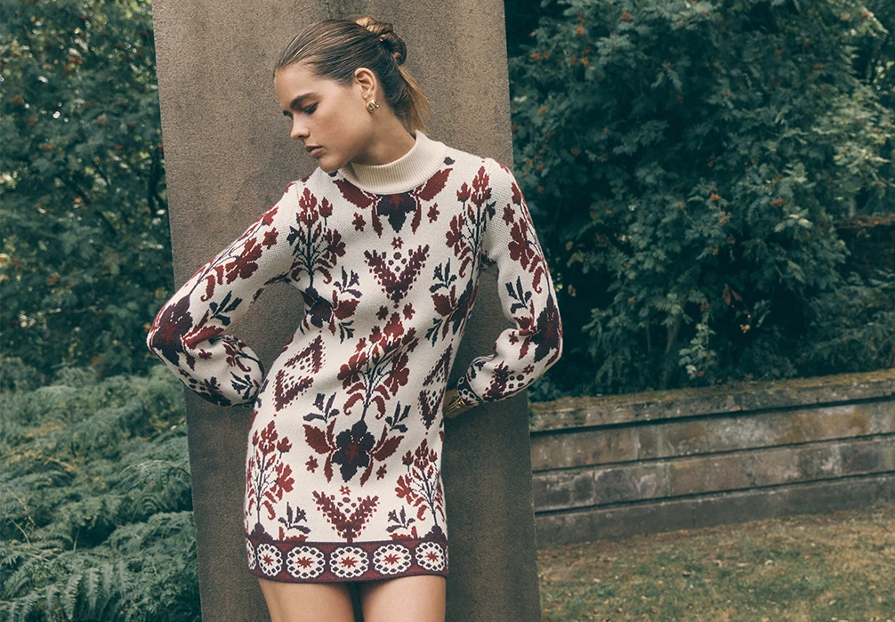 Model is wearing a Folk Floral Mini Jumper Dress