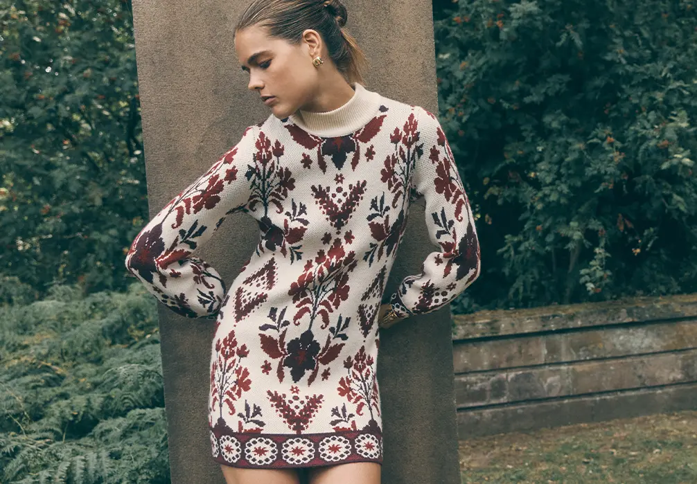 Model is wearing a knitted jumper dress