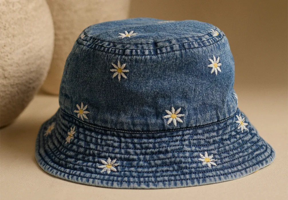 Studio shot of the Embroidered Daisy Cotton Bucket Hat