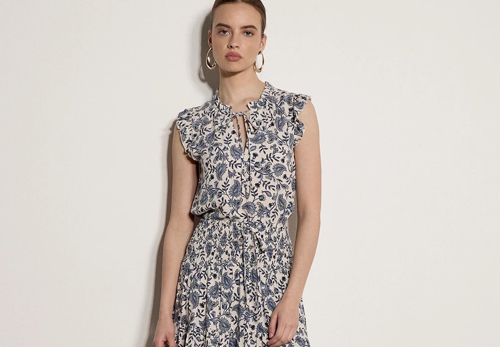 Model is wearing the Painterly Paisley Ruffle Top