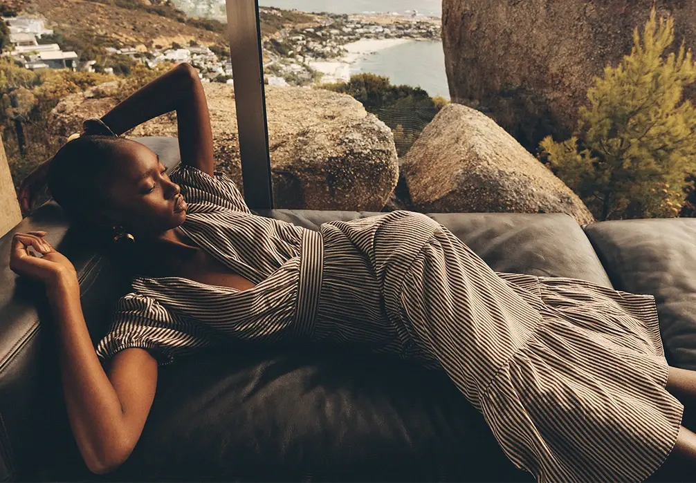 Model lying down wearing a Stripe Wrap Midaxi Dress